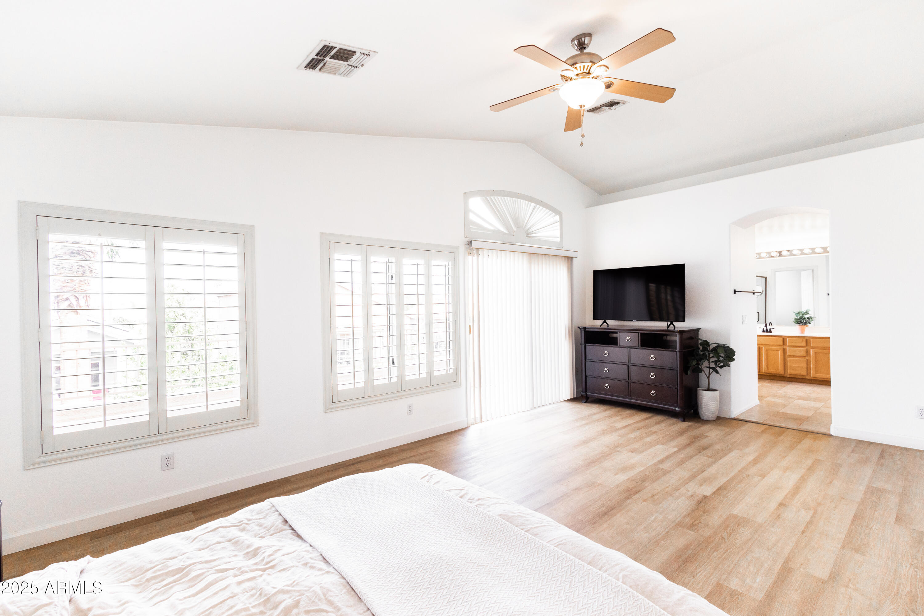 696 West Del Rio Street Gilbert, AZ 85233 - Photo 24 of 39 a large bedroom with furniture and a flat screen tv