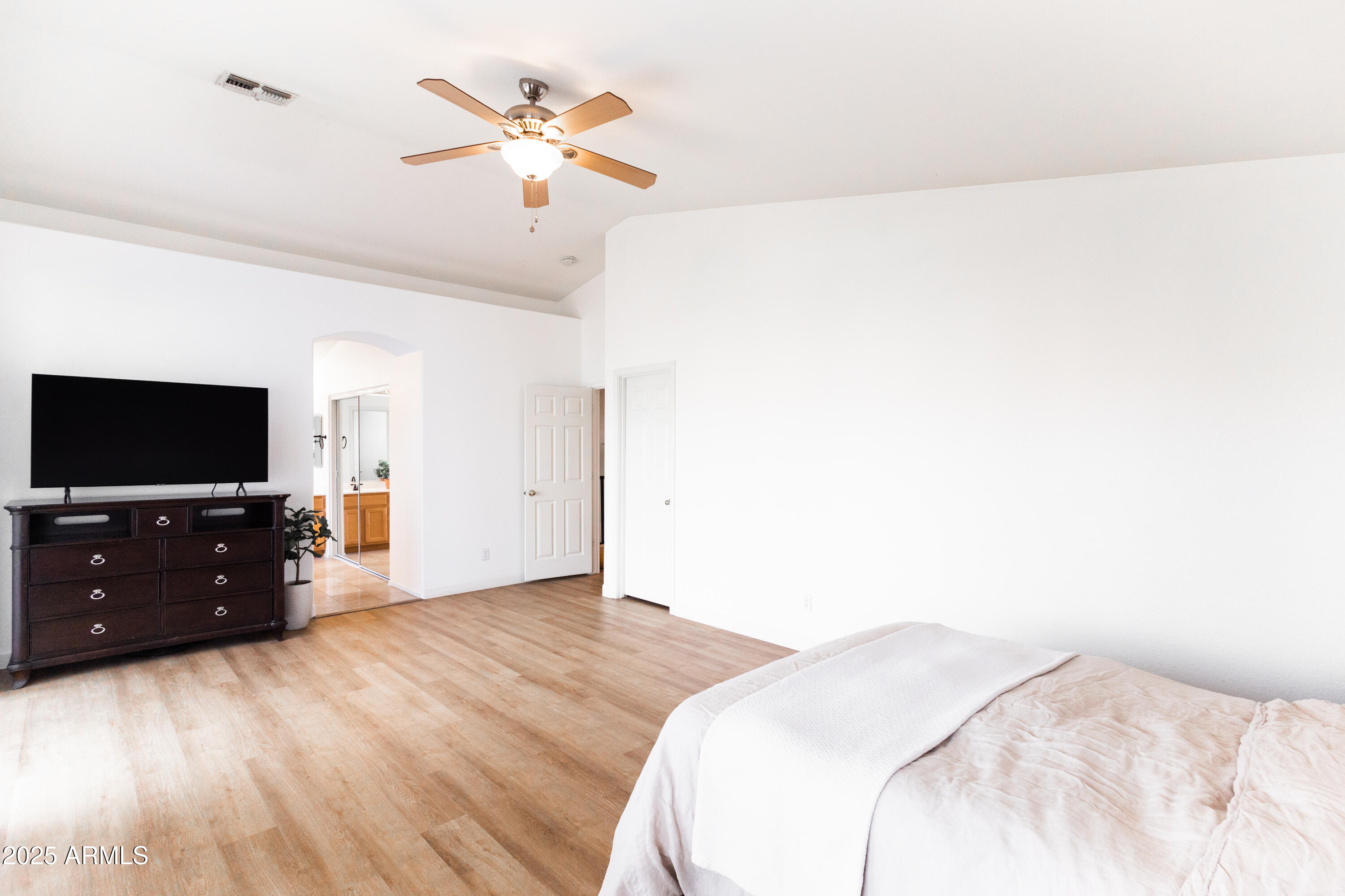 696 West Del Rio Street Gilbert, AZ 85233 - Photo 25 of 39 a bedroom with a bed and a flat tv screen on dresser