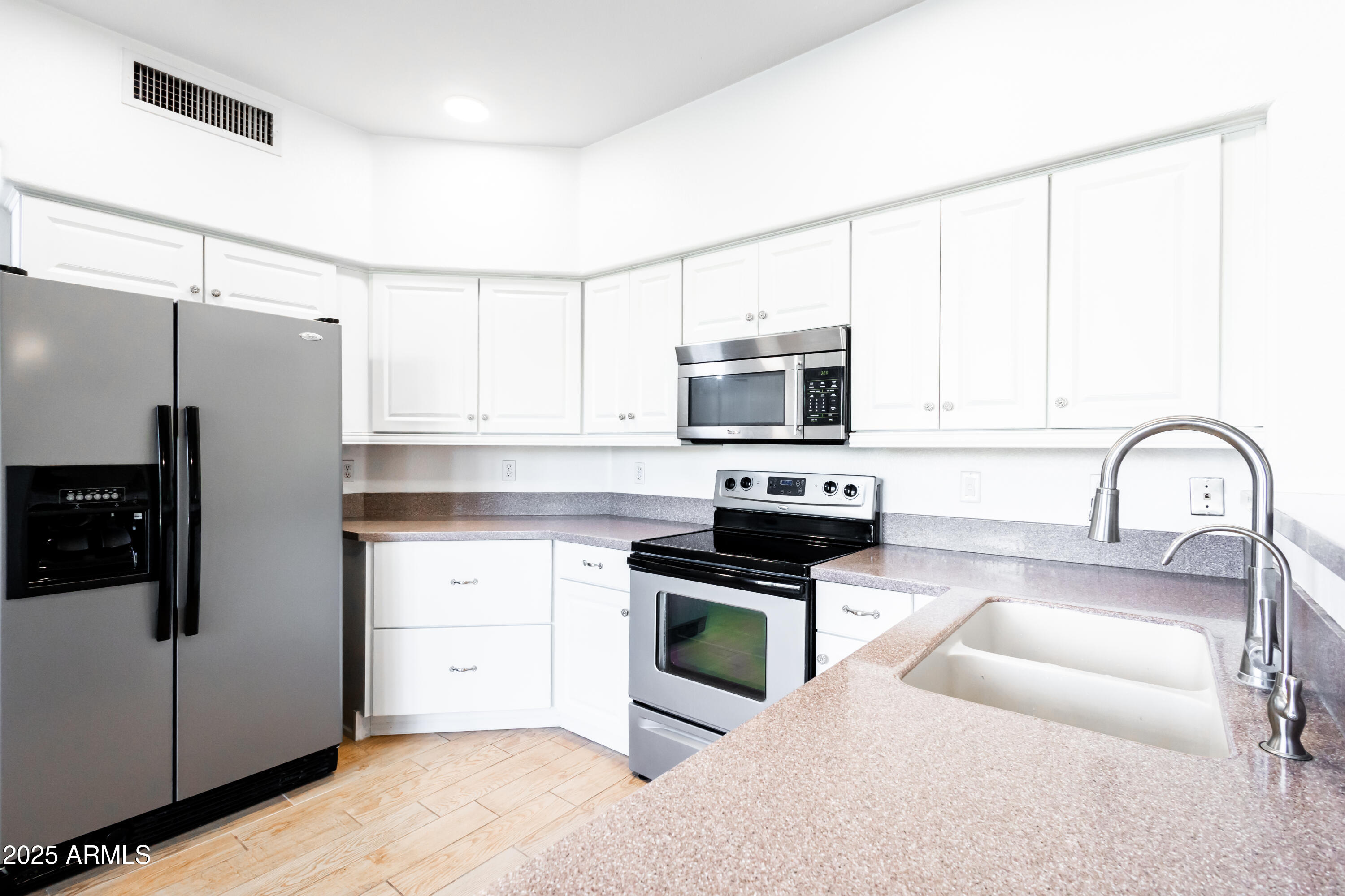 696 West Del Rio Street Gilbert, AZ 85233 - Photo 9 of 39 a kitchen with stainless steel appliances a stove microwave and sink