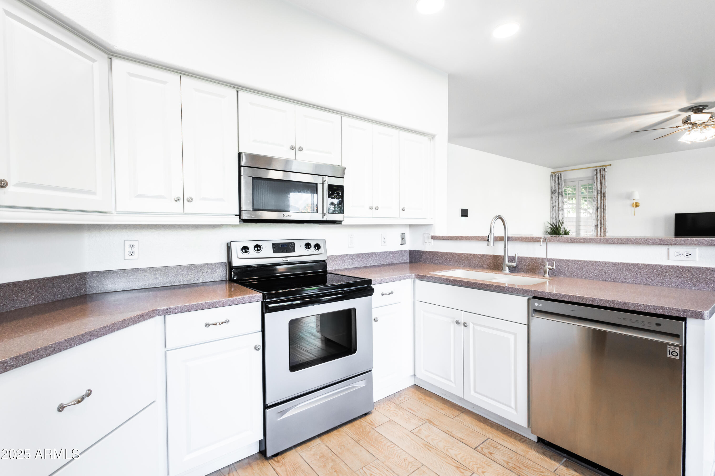 696 West Del Rio Street Gilbert, AZ 85233 - Photo 10 of 39 a kitchen with granite countertop white cabinets and white appliances