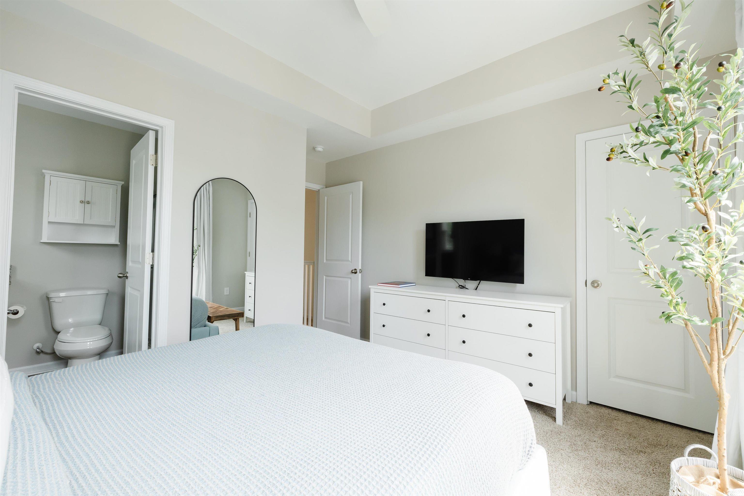 3553 Ladybank Loop Myrtle Beach, SC 29577 - Photo 21 of 30 Bedroom with light colored carpet and ensuite bath