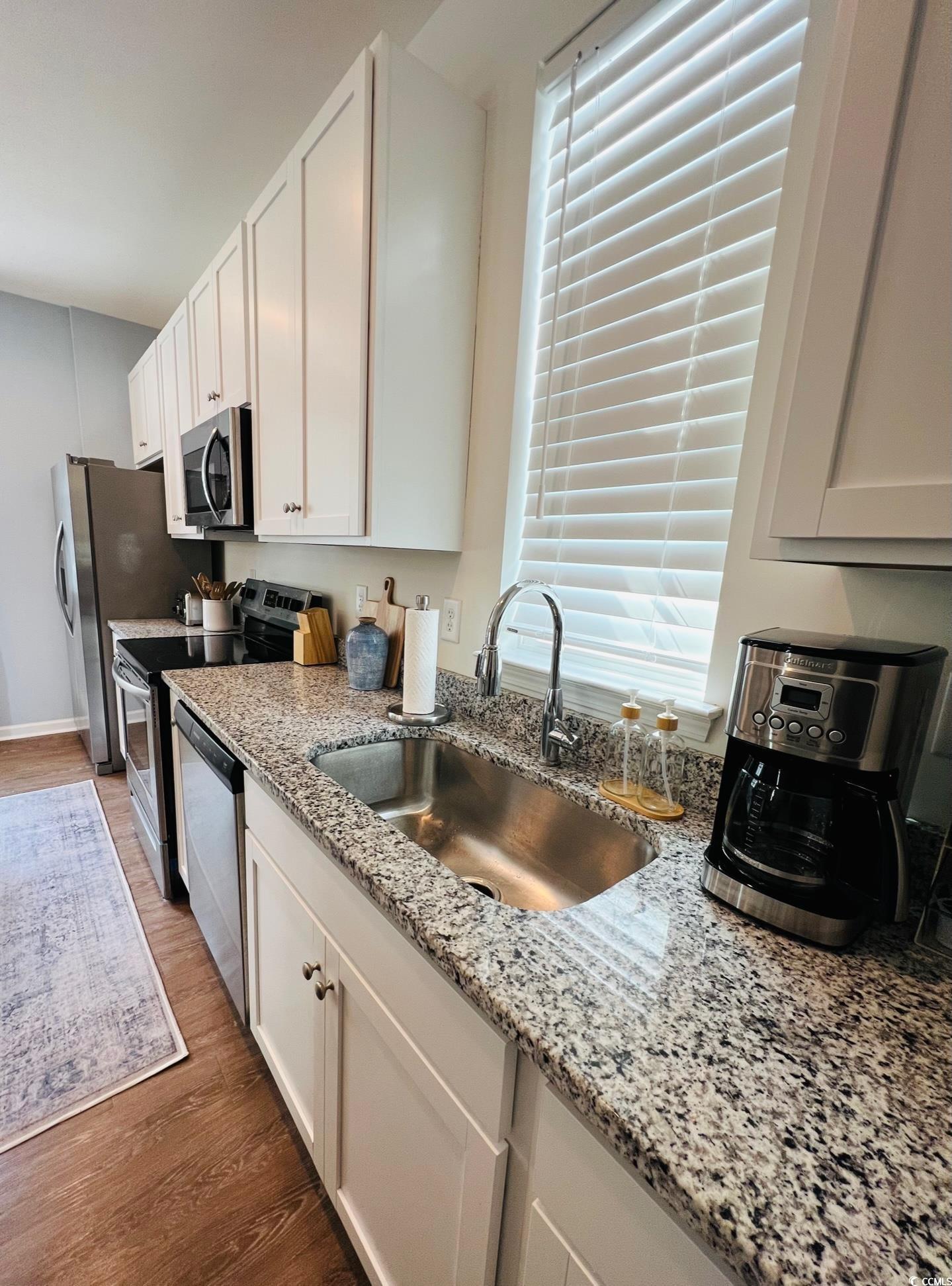 3553 Ladybank Loop Myrtle Beach, SC 29577 - Photo 6 of 30 Kitchen with white cabinetry, appliances with stai