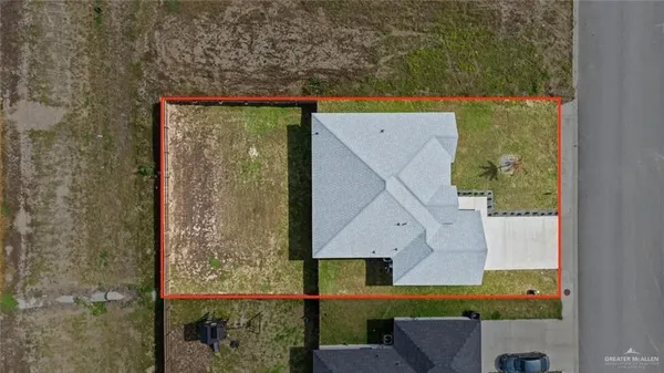 an aerial view of a house with a yard