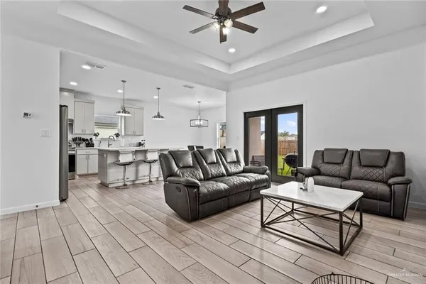 a living room with furniture and kitchen view