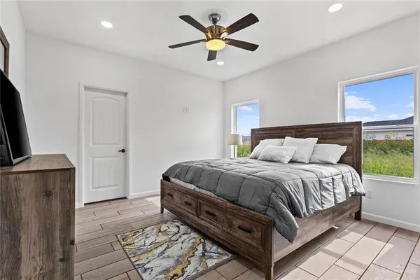 a bed sitting in a bedroom next to a window