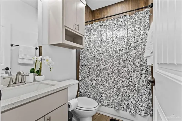 a bathroom with a sink toilet and shower
