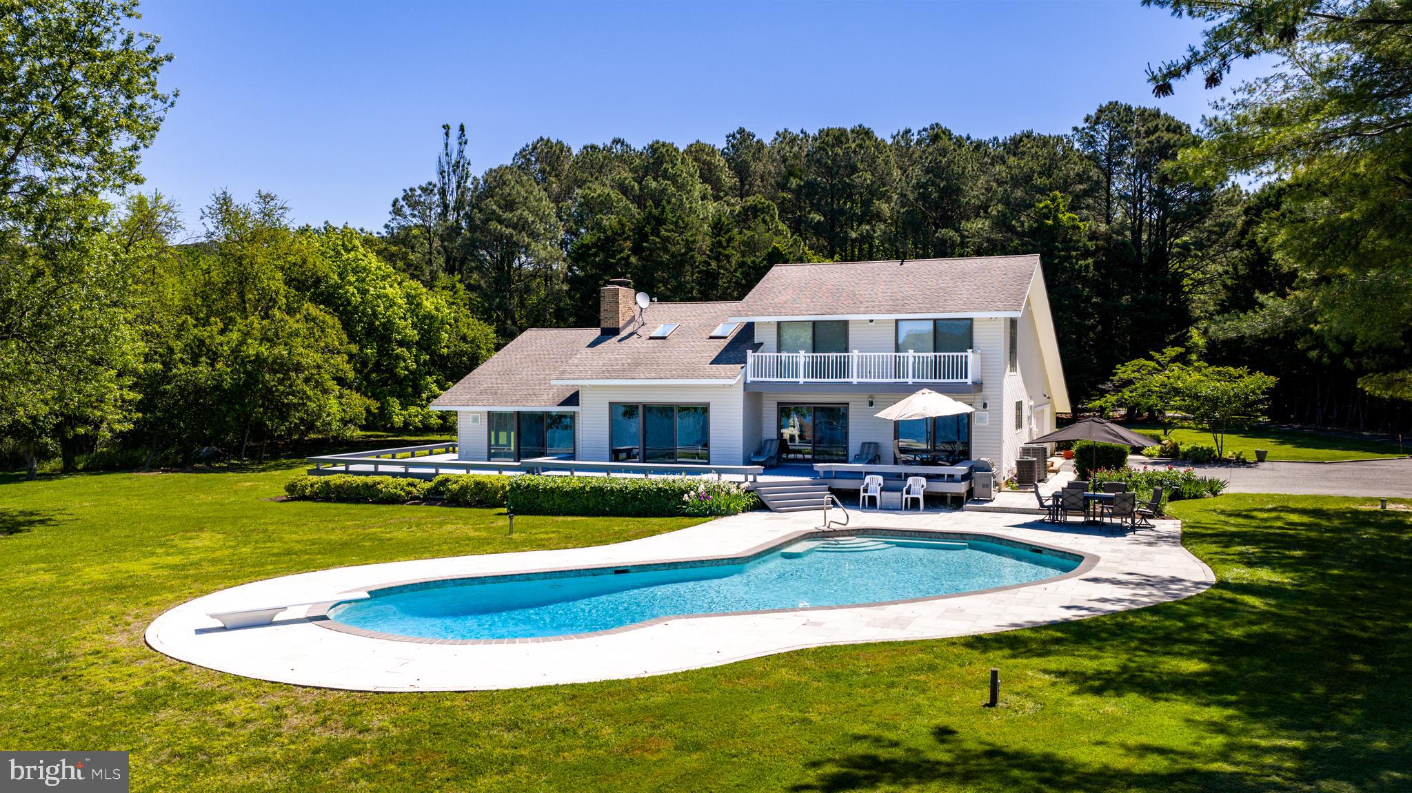 26282 Deep Water Harbor Road Easton, MD 21601 - Photo 4 of 53 a view of a house with swimming pool and yard