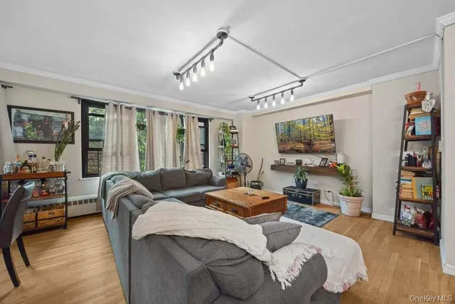 a bedroom with a bed couch and a window