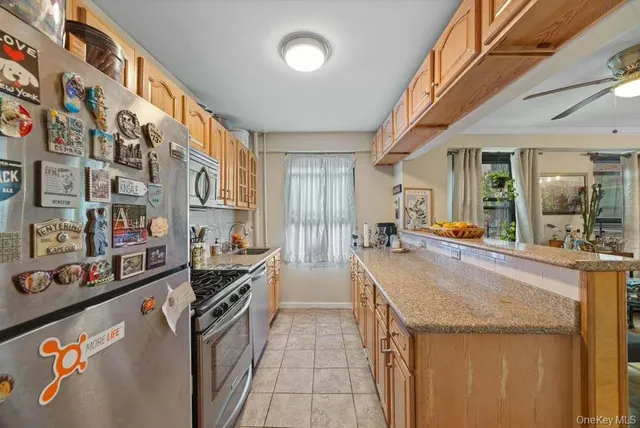 a kitchen with stainless steel appliances granite countertop a sink and cabinets