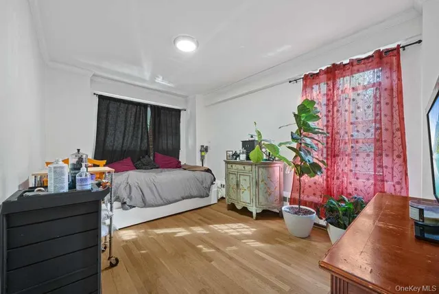 a bedroom with bed and a potted plant