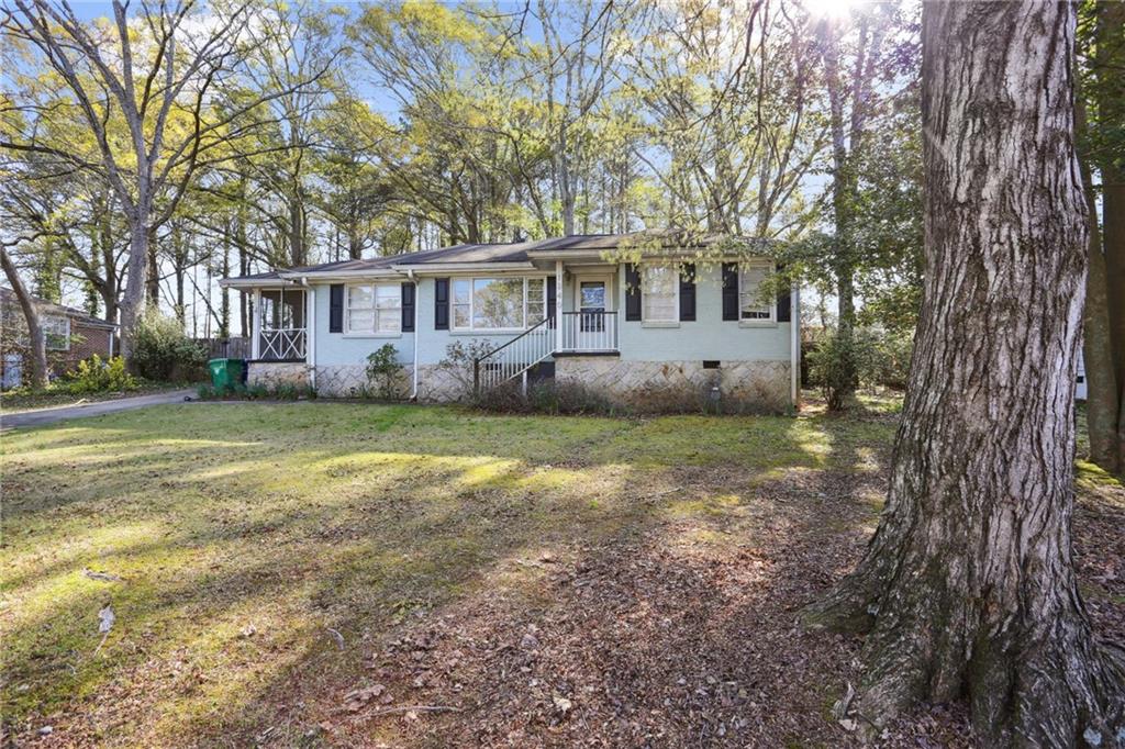 1340 Oldfield Road Decatur, GA 30030 - Photo 1 of 1 a front view of a house with a garden and trees