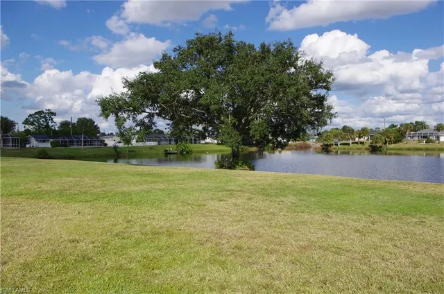 a view of a lake with houses in the back