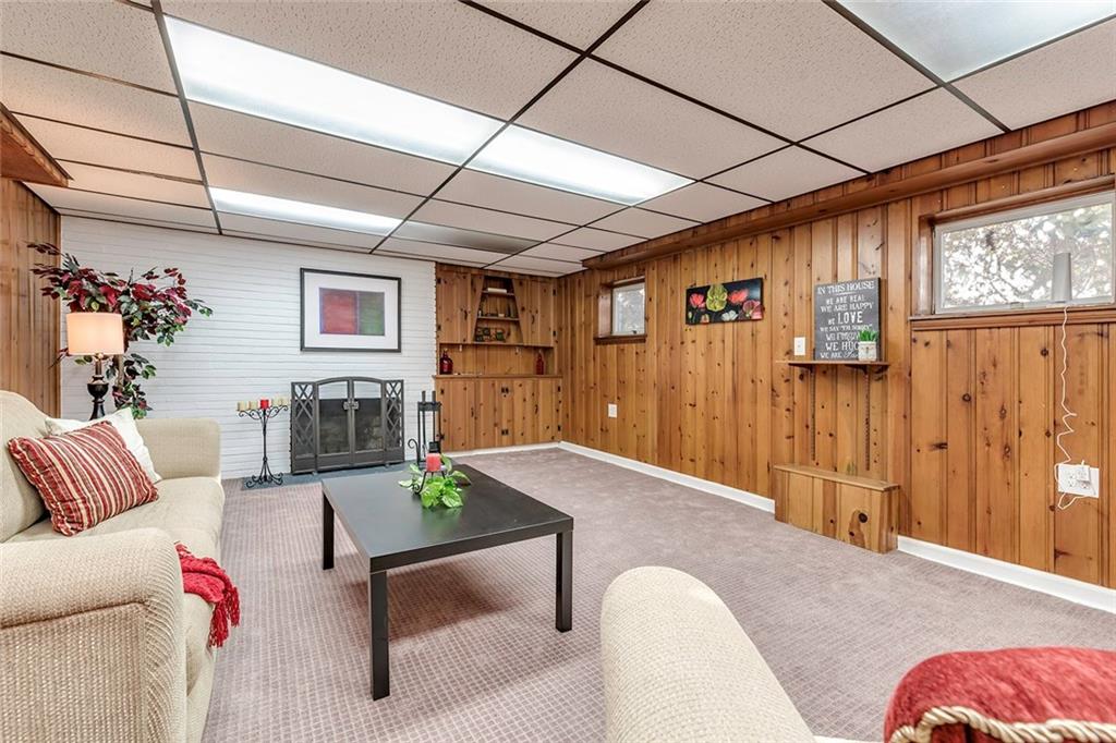 2519 Collins Road Pittsburgh, PA 15235 - Photo 21 of 25 The Lower Level Also Features Built-In Bookcases/Cabinetry for Additional Storage, a Decorative Fireplace and New Carpet