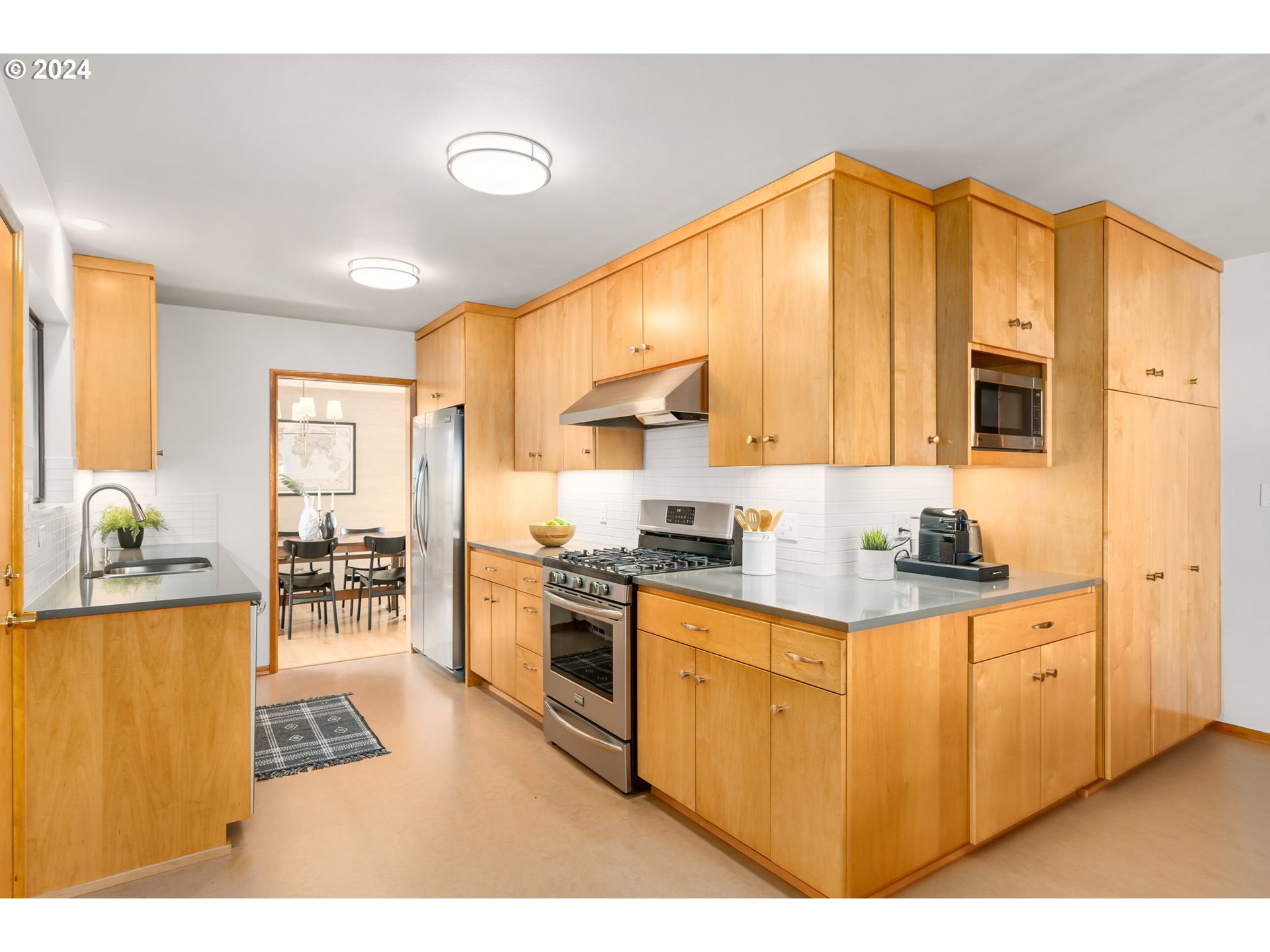 3228 Southwest Hamilton Street Portland, OR 97239 - Photo 14 of 46 a kitchen with stainless steel appliances granite countertop a stove a sink dishwasher and a refrigerator