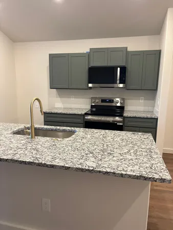 a kitchen with a sink and a stove top oven