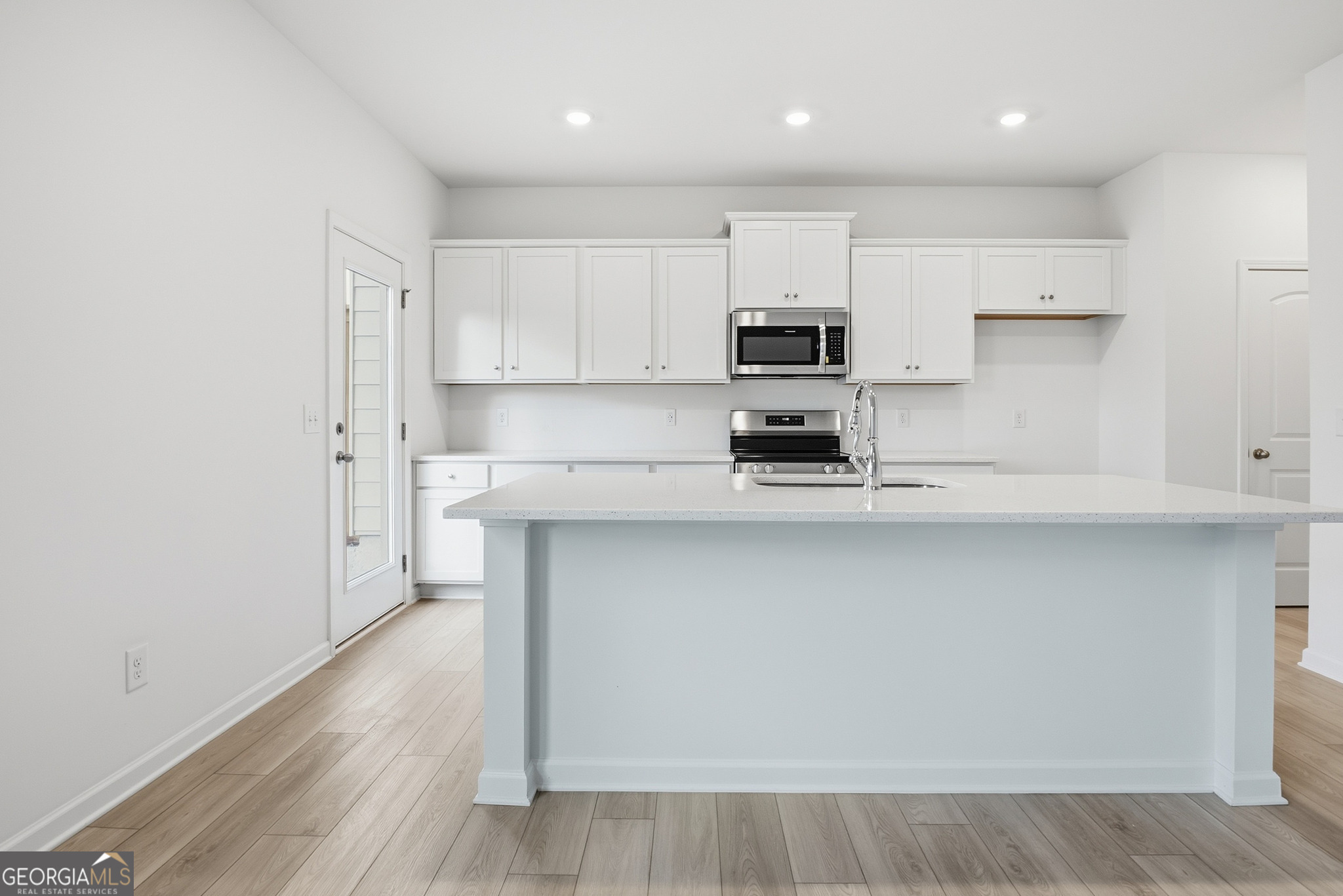 32 Umber Lane Newnan, GA 30263 - Photo 5 of 8 a kitchen with stainless steel appliances a sink a stove a microwave and cabinets
