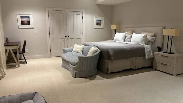 a bedroom with a bed and chair