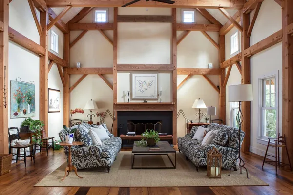 a living room with furniture a fireplace and a floor to ceiling window