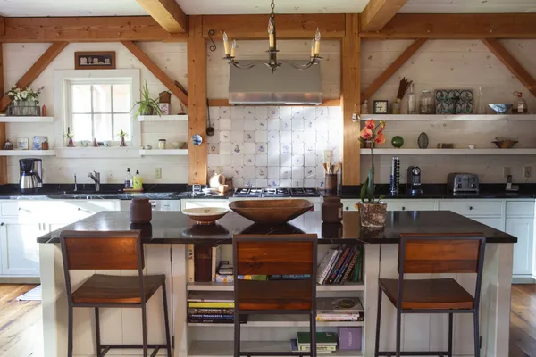 a kitchen with a table chairs stove and cabinets