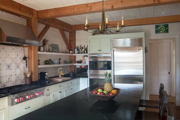 a kitchen with stainless steel appliances granite countertop a refrigerator and a stove
