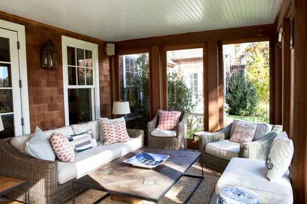 a living room with furniture and floor to ceiling windows