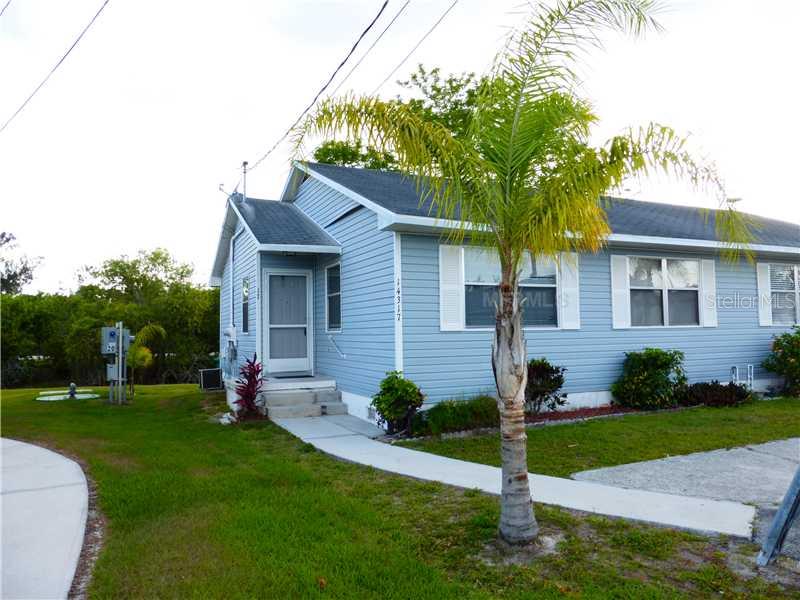 14317 Worthwhile Road Port Charlotte, FL 33953 - Photo 1 of 1 a front view of a house with a yard
