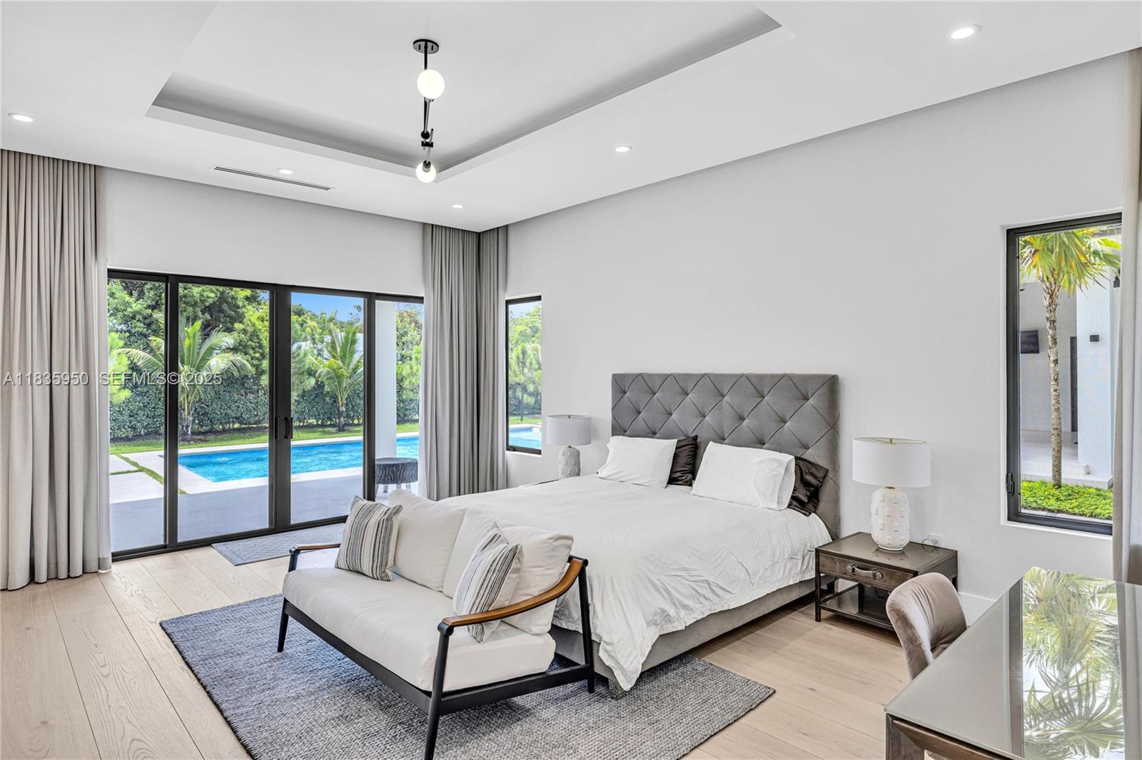 7699 Southwest 118th Street Pinecrest, FL 33156 - Photo 11 of 38 a bedroom with a large bed and a large window