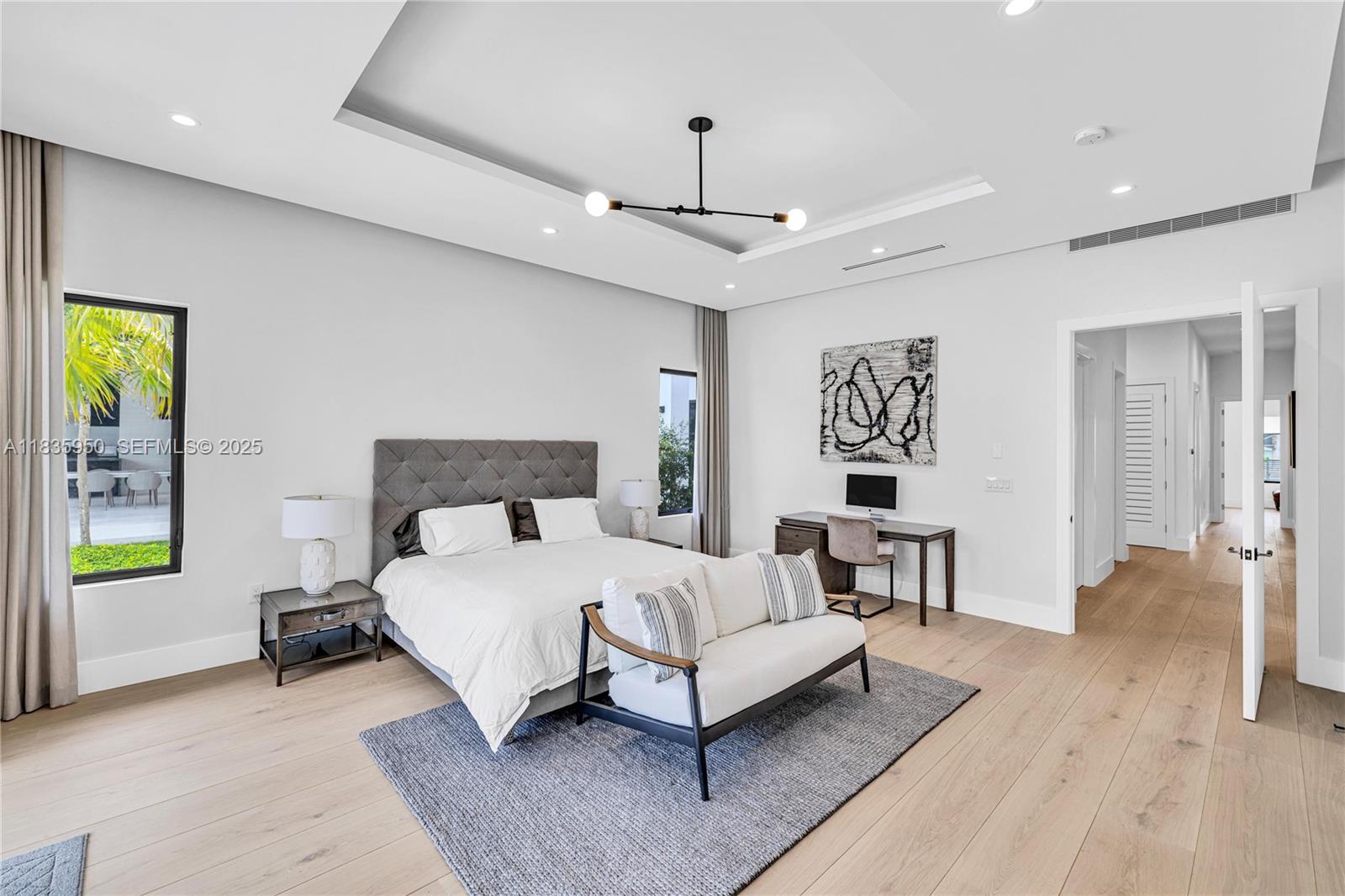 7699 Southwest 118th Street Pinecrest, FL 33156 - Photo 12 of 38 a bedroom with a bed chandelier and a window
