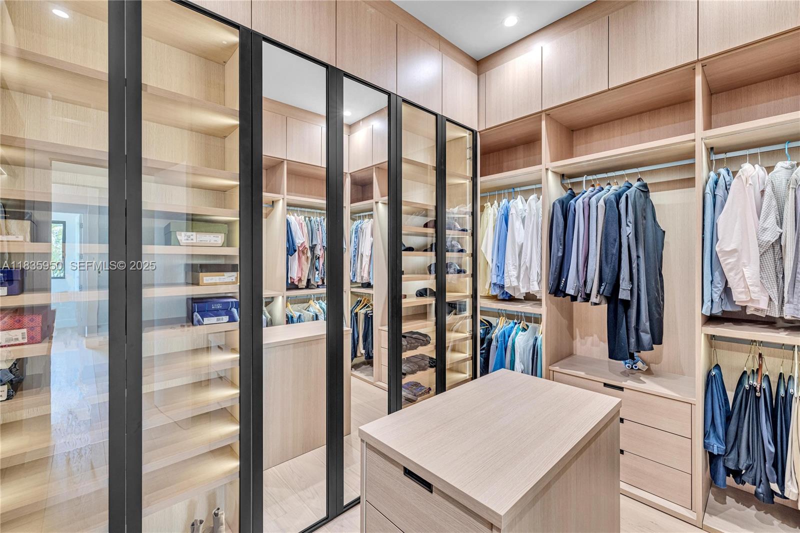 7699 Southwest 118th Street Pinecrest, FL 33156 - Photo 14 of 38 a view of walk in closet with clothes and shoes