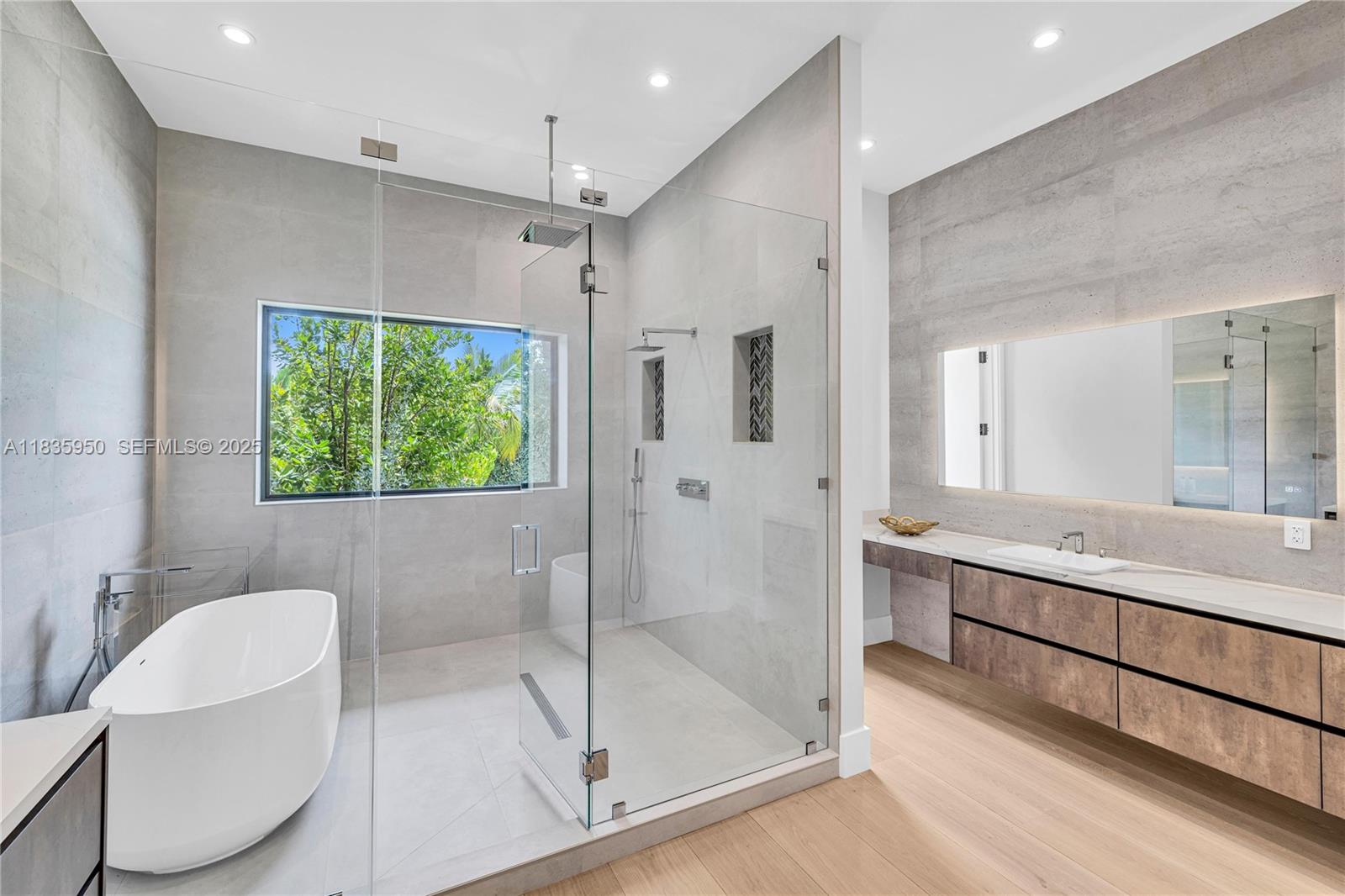 7699 Southwest 118th Street Pinecrest, FL 33156 - Photo 16 of 38 a bathroom with a granite countertop sink a toilet a mirror and shower