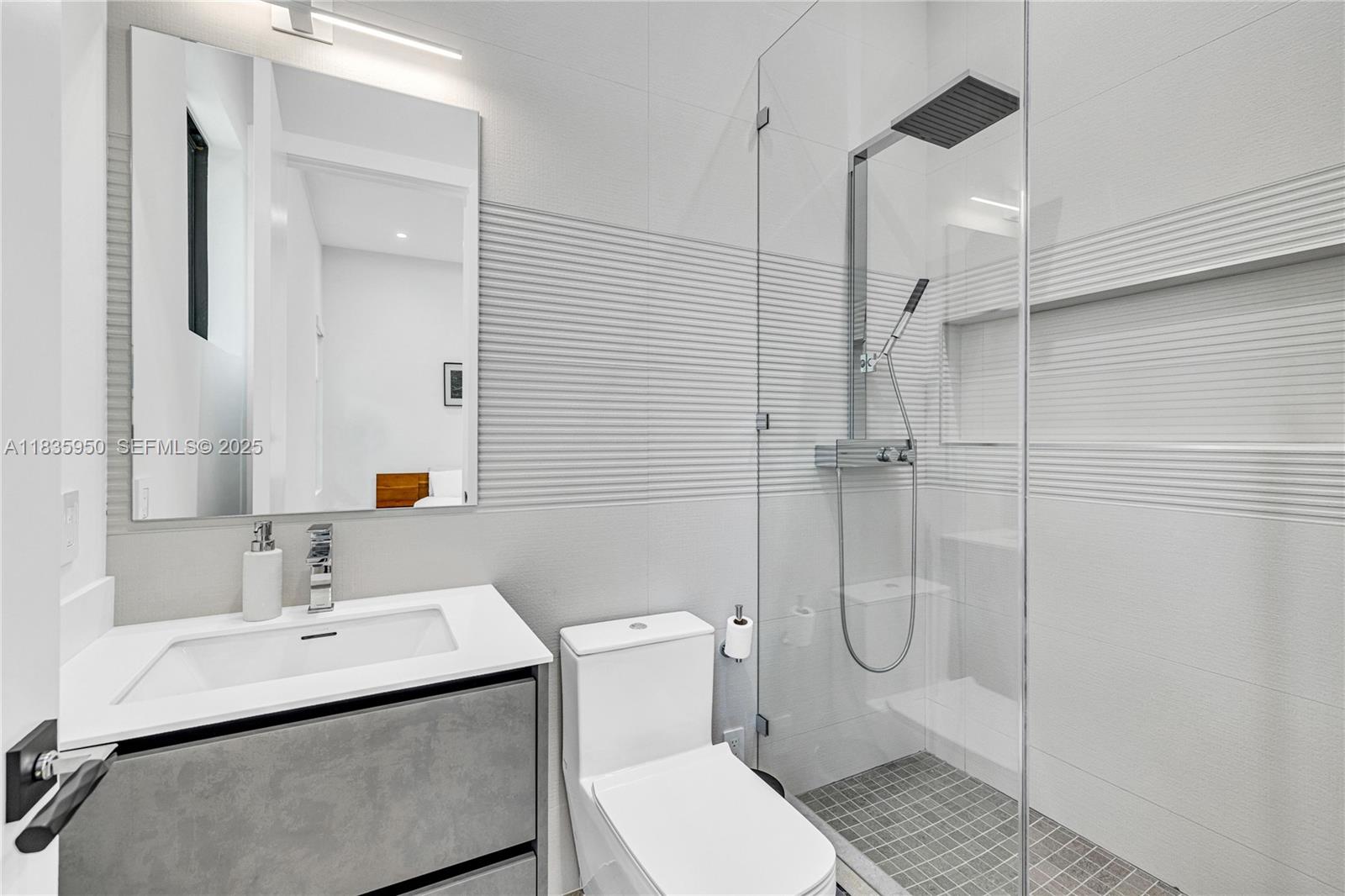 7699 Southwest 118th Street Pinecrest, FL 33156 - Photo 19 of 38 a bathroom with a sink toilet and shower