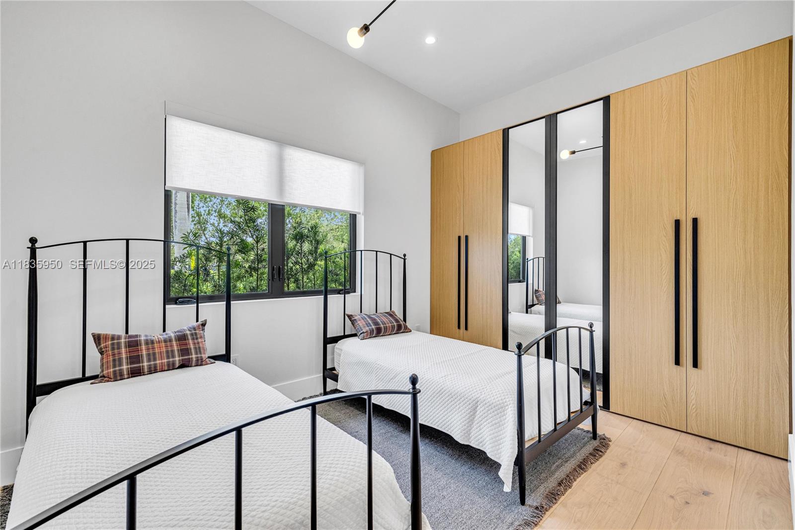 7699 Southwest 118th Street Pinecrest, FL 33156 - Photo 25 of 38 a bedroom with a bed and large window