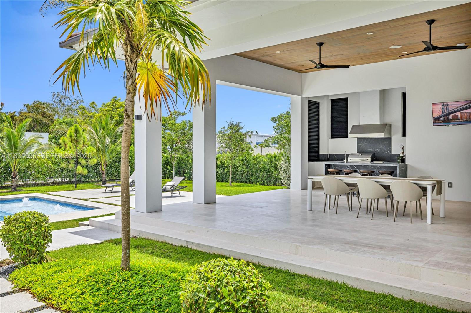 7699 Southwest 118th Street Pinecrest, FL 33156 - Photo 29 of 38 a view of a patio with a table and chairs