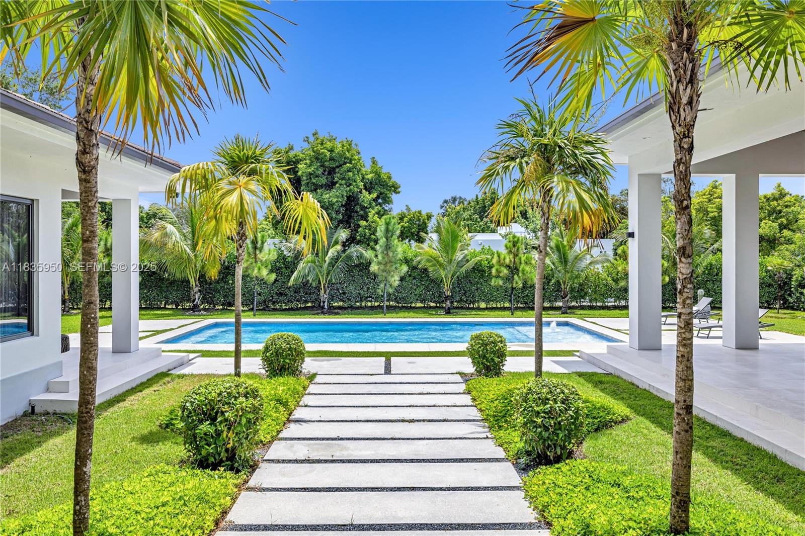 7699 Southwest 118th Street Pinecrest, FL 33156 - Photo 34 of 38 a view of swimming pool with a table and chairs