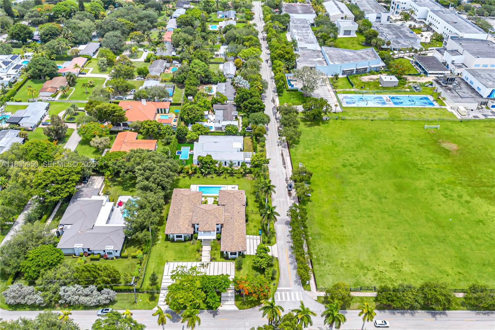 7699 Southwest 118th Street Pinecrest, FL 33156 - Photo 38 of 38 an aerial view of residential houses with outdoor space and trees