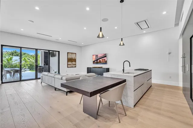 a kitchen with stainless steel appliances granite countertop a sink and a refrigerator