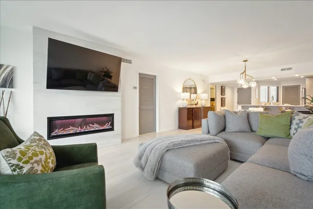a living room with furniture fireplace and flat screen tv