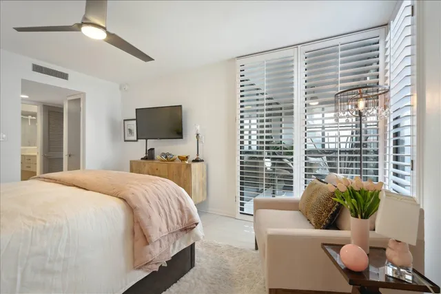 a bedroom with bed couch and window