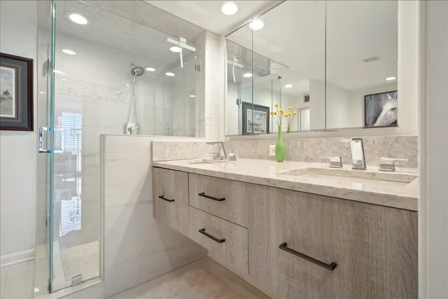 a bathroom with a granite countertop sink mirror and double