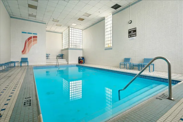 a view of a kitchen with kitchen island a sink and wooden floor