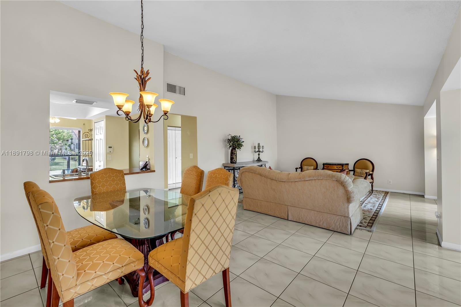 2000 Southwest 15th Place Deerfield Beach, FL 33442 - Photo 12 of 33 a living room with dining table and a chandelier