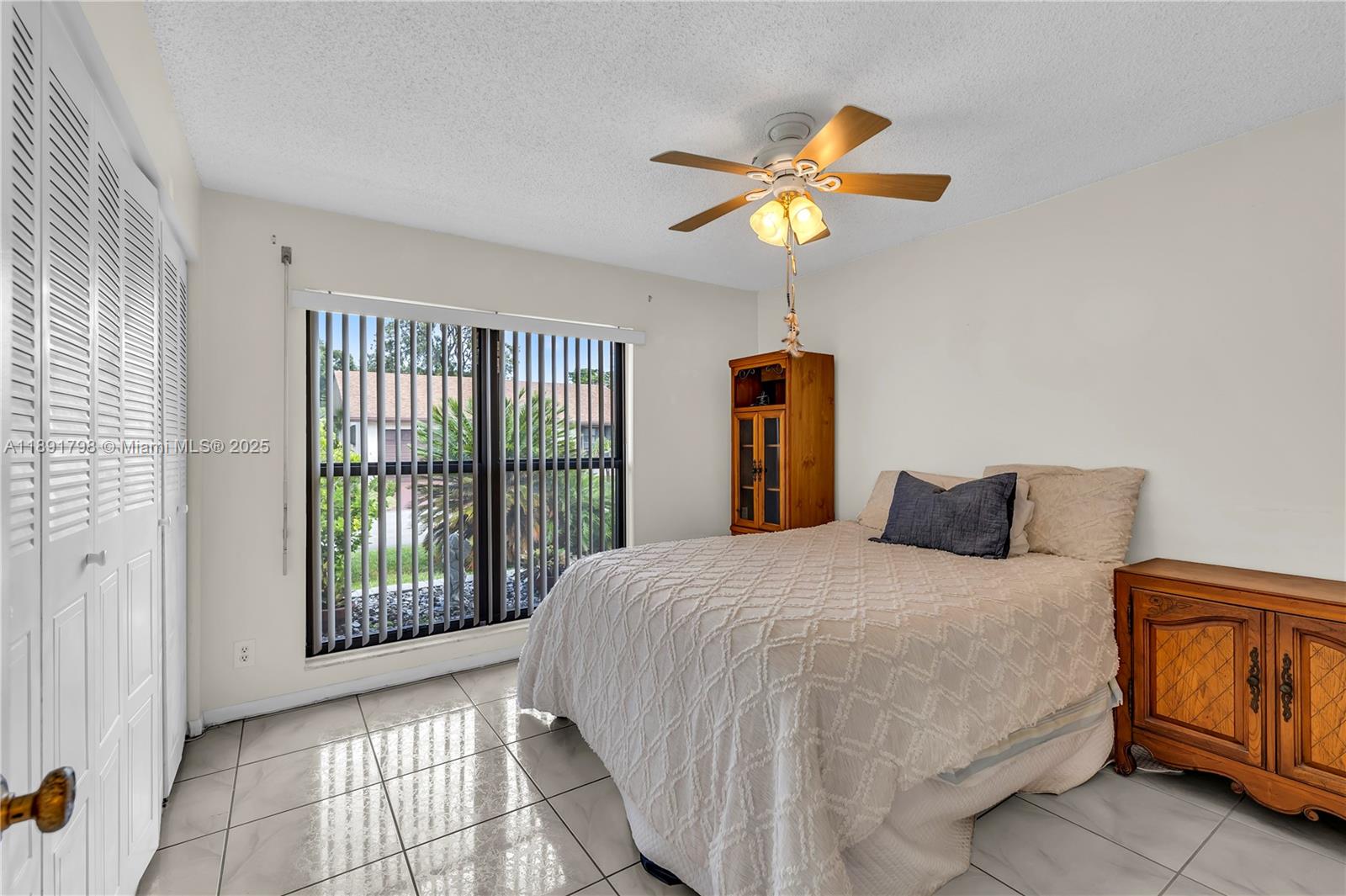 2000 Southwest 15th Place Deerfield Beach, FL 33442 - Photo 19 of 33 a bedroom with a bed and a chandelier