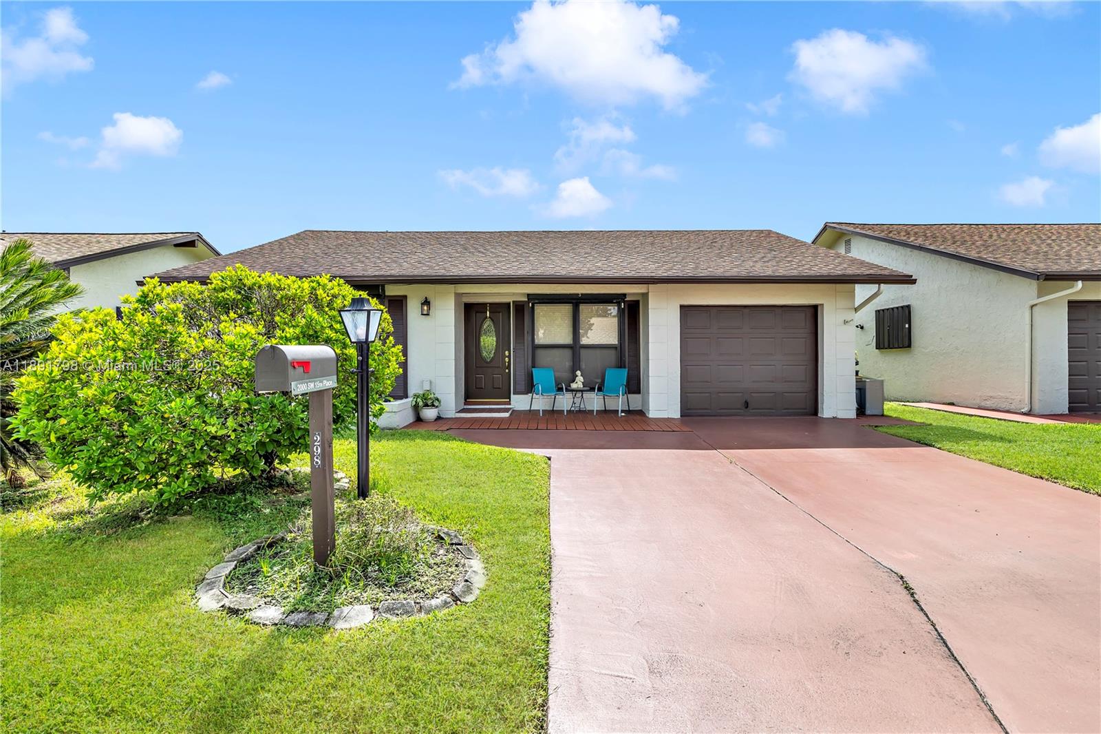 2000 Southwest 15th Place Deerfield Beach, FL 33442 - Photo 2 of 33 a front view of a house with a yard and garage