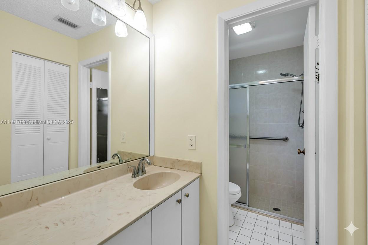 2000 Southwest 15th Place Deerfield Beach, FL 33442 - Photo 23 of 33 a bathroom with a granite countertop sink a mirror and a shower