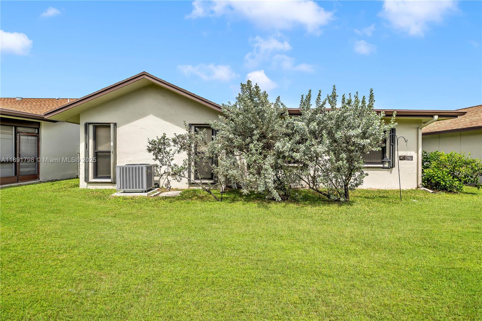 2000 Southwest 15th Place Deerfield Beach, FL 33442 - Photo 25 of 33 a front view of a house with garden