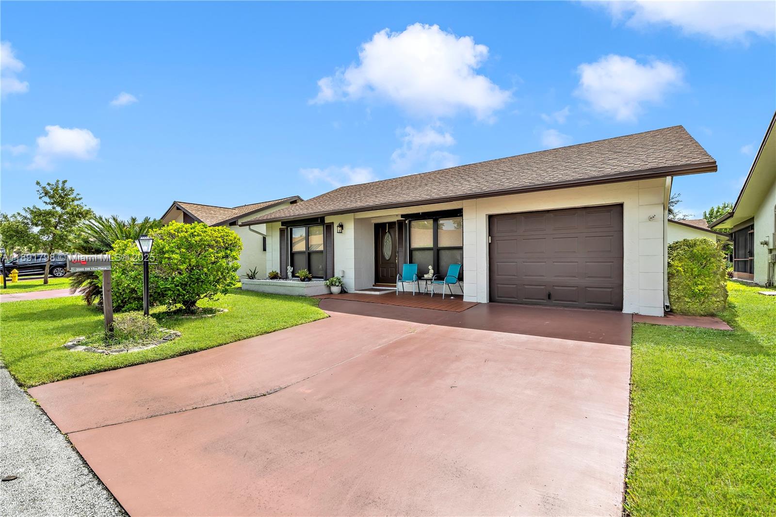 2000 Southwest 15th Place Deerfield Beach, FL 33442 - Photo 3 of 33 a view of yellow house with a yard and potted plants