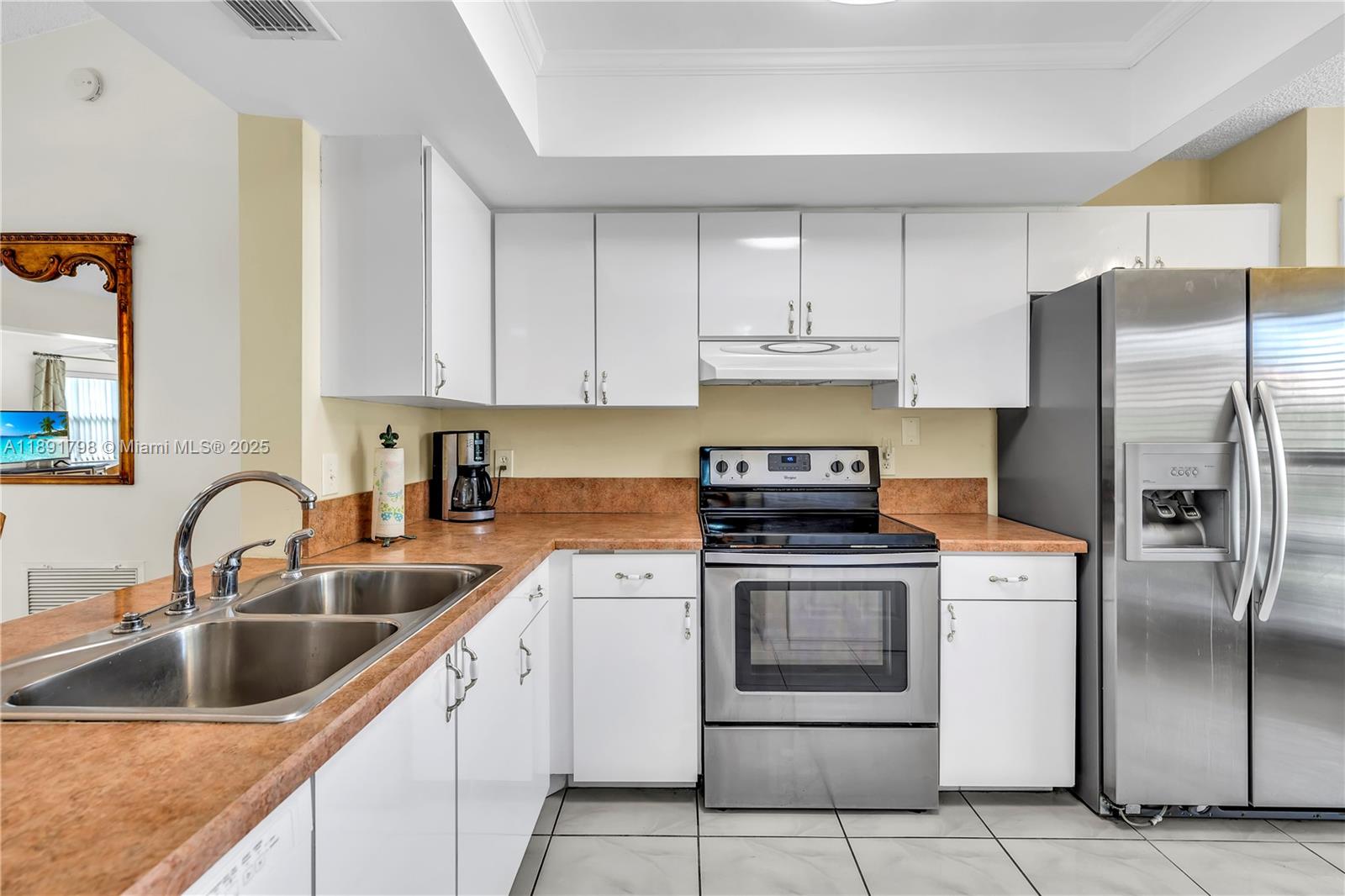 2000 Southwest 15th Place Deerfield Beach, FL 33442 - Photo 6 of 33 a kitchen with a sink stove and refrigerator