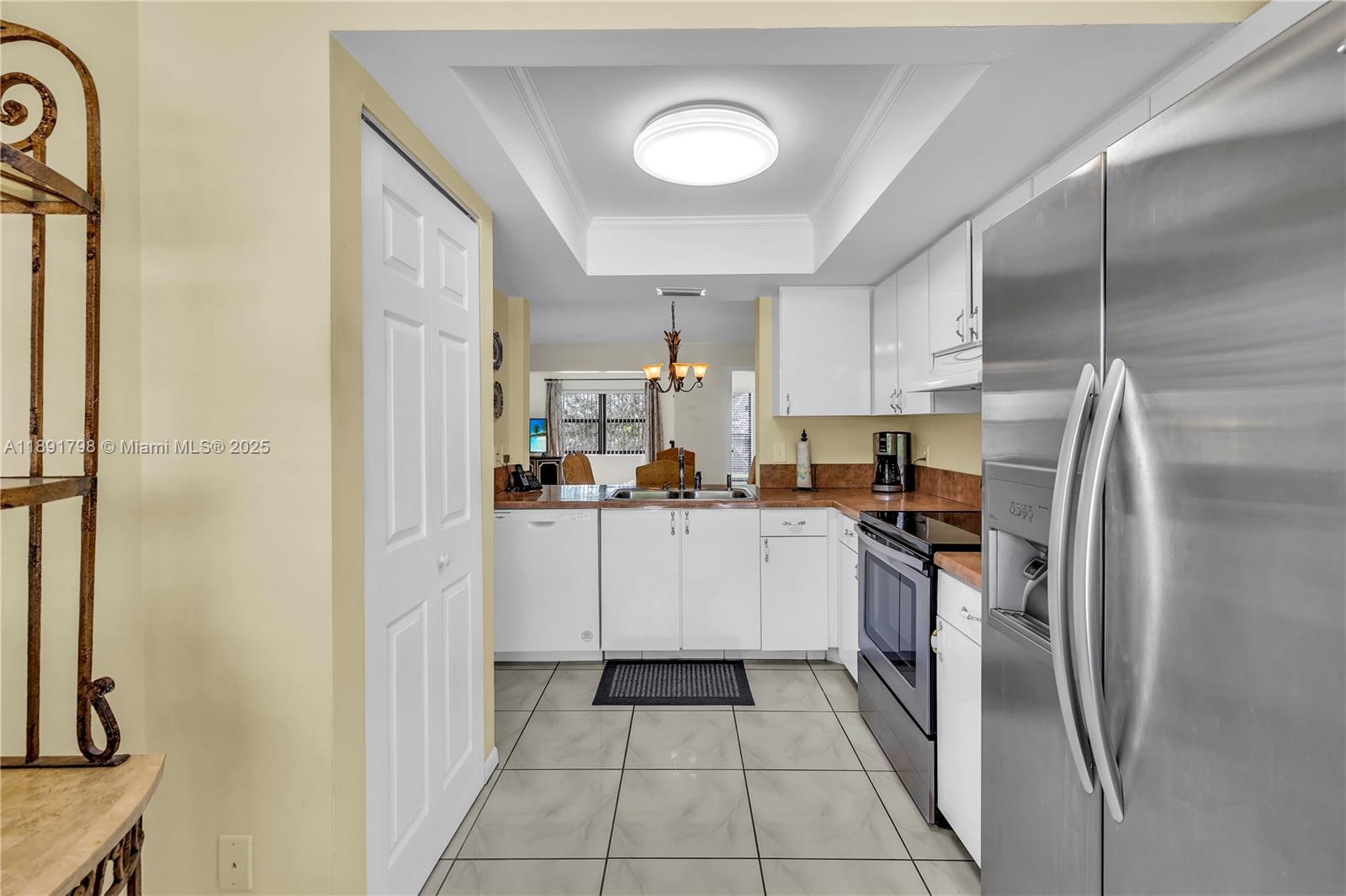 2000 Southwest 15th Place Deerfield Beach, FL 33442 - Photo 7 of 33 a kitchen with a refrigerator and a sink