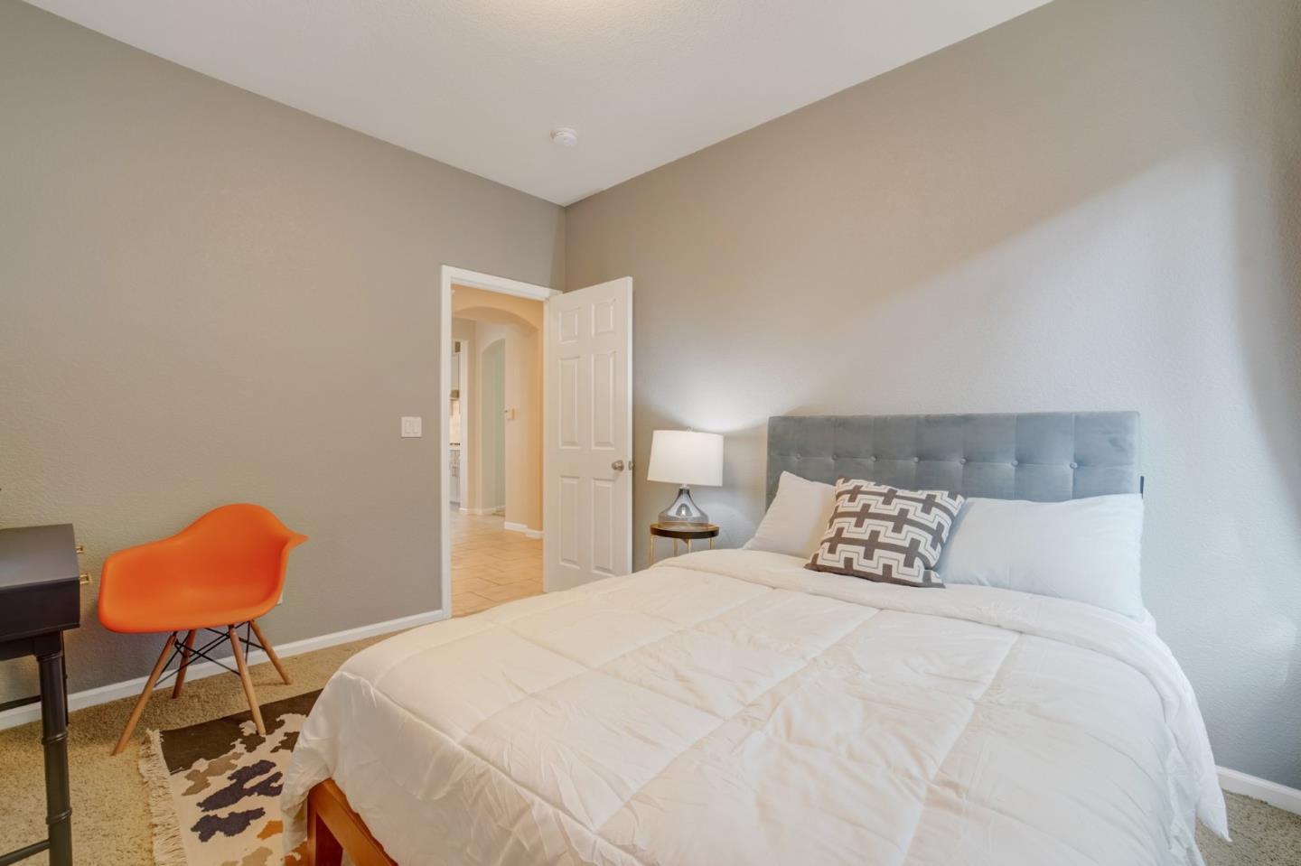 113 Lance Court Martinez, CA 94553 - Photo 20 of 25 a bedroom with a bed a chair and a potted plant