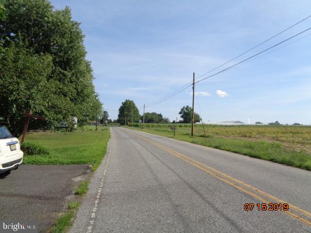 17 Tilbury Road Salem, NJ 08079 - Photo 2 of 17 a view of a road with a big yard and large trees